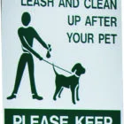 Pet waste sign instructing to leash and clean up after pets. Please keep area clean.