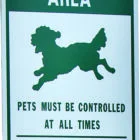 Pet Exercise Area sign: Pets must be controlled at all times. Please clean up after your pet.