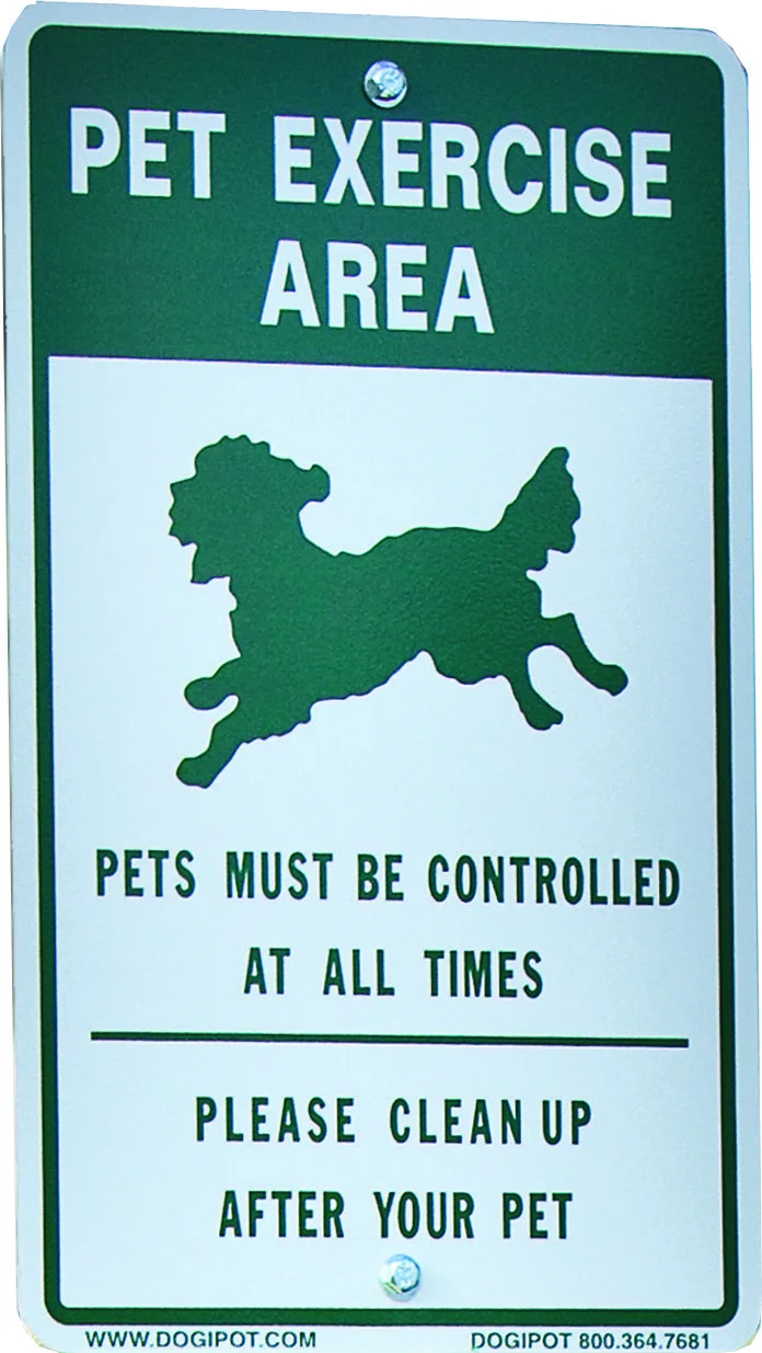 Pet Exercise Area sign: Pets must be controlled at all times. Please clean up after your pet.