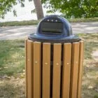 Outdoor trash can in a park setting.