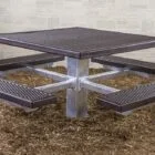 Outdoor picnic table with four seats and a metal top.