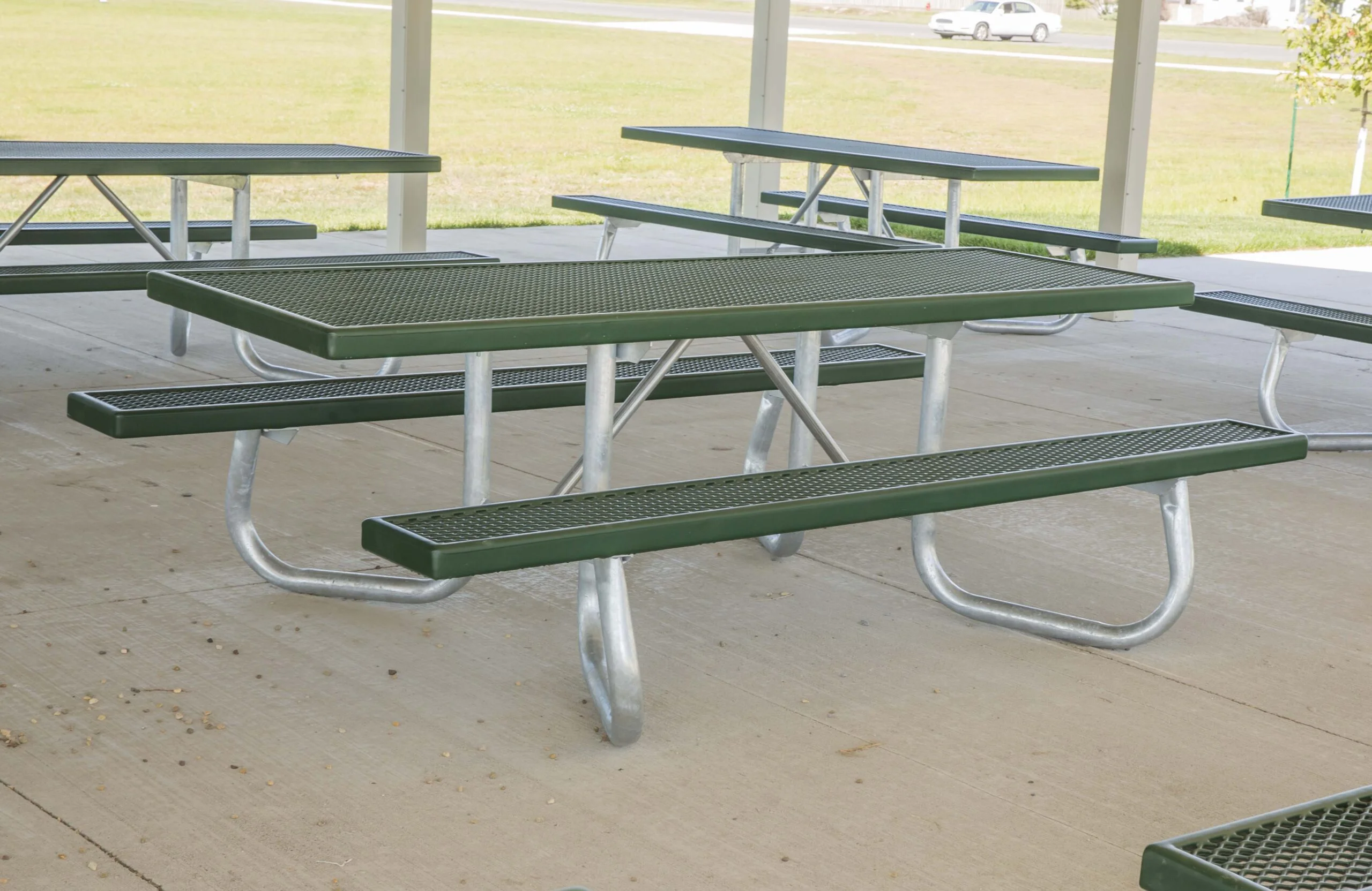 Outdoor picnic tables in a park setting.