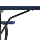 Blue and black metal table with a curved armrest.