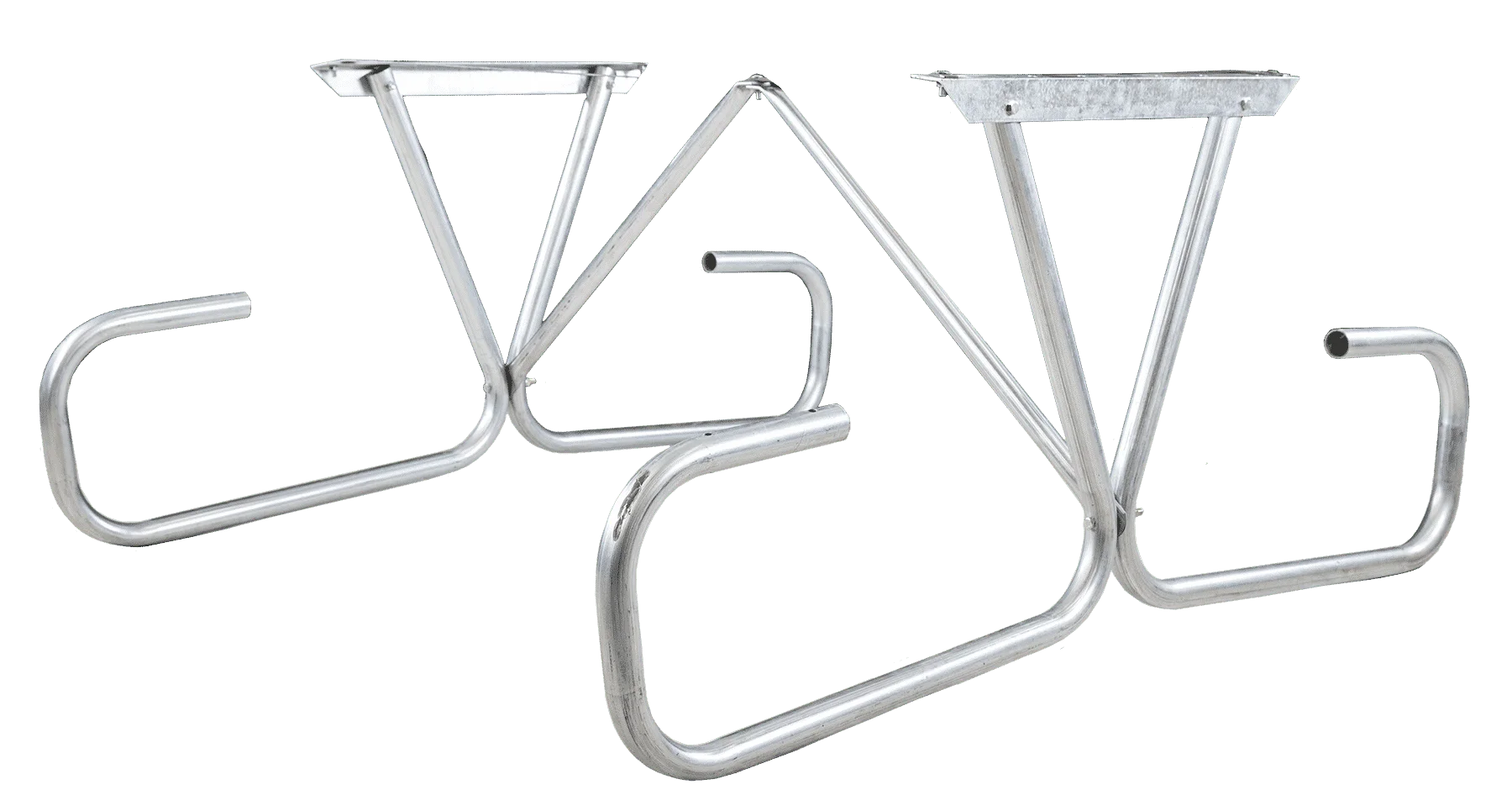 Silver metal bike rack on green background.