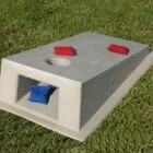 Cornhole toss game set on grass.