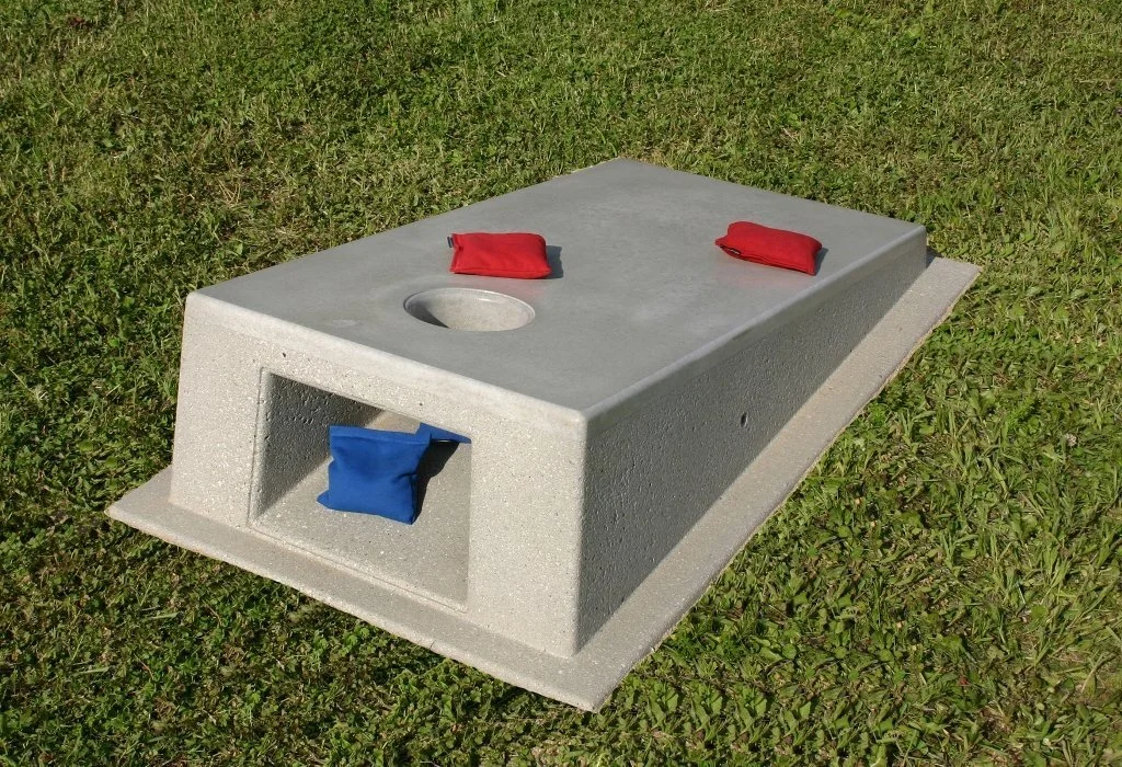 Cornhole toss game set on grass.