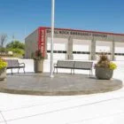 Shel Rock Emergency Services building with benches and flower pots.