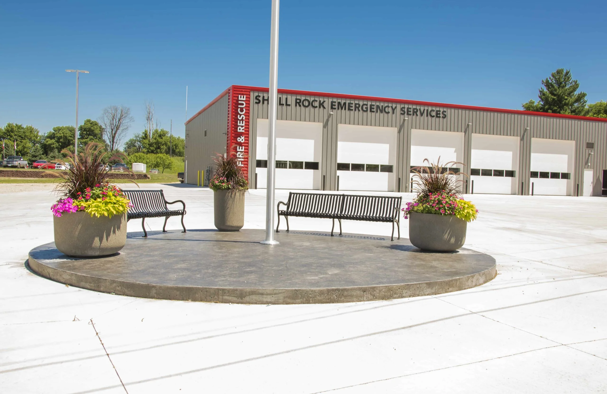 Shel Rock Emergency Services building with benches and flower pots.