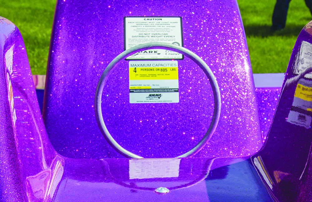 Purple inflatable pool float with safety instructions and capacity label.