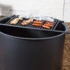 Outdoor grill cooking chicken and hot dogs.