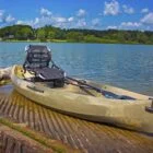 Kayak on dock with paddle and seat.