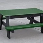 Green and black picnic table on a concrete surface.