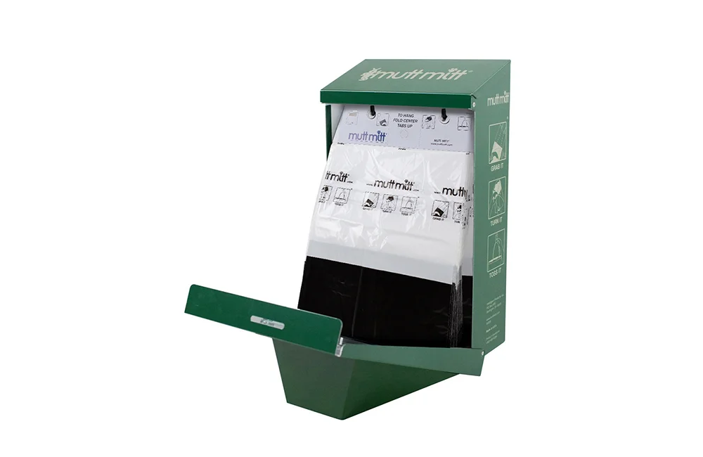 Green trash bin with a pull-out tray and white bags inside.