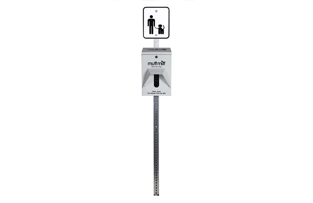 Dog waste bag dispenser on a pole.
