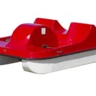 Red and white pedal boat on a white background.
