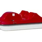 Red and white pedal boat on a white background.