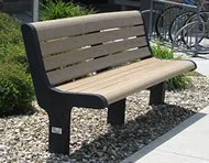Wooden bench in a garden setting.