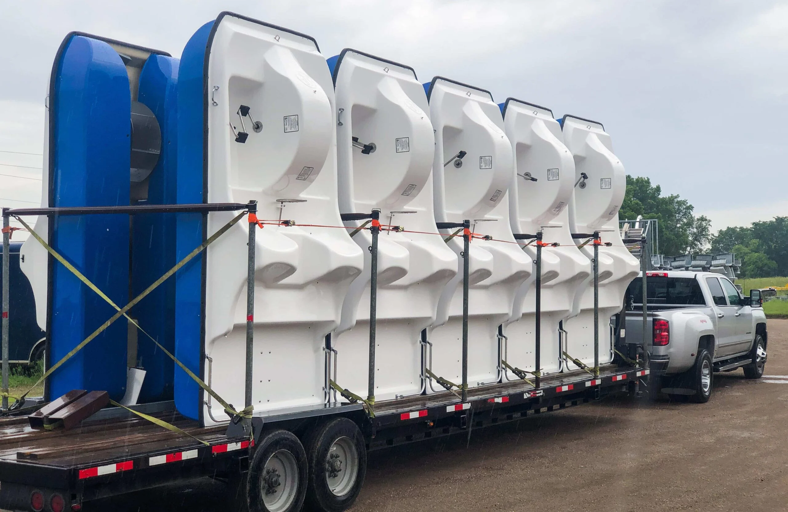 Large white and blue structures on a flatbed trailer.
