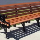 Wooden bench on a sidewalk.