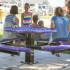 Children playing at a park table.