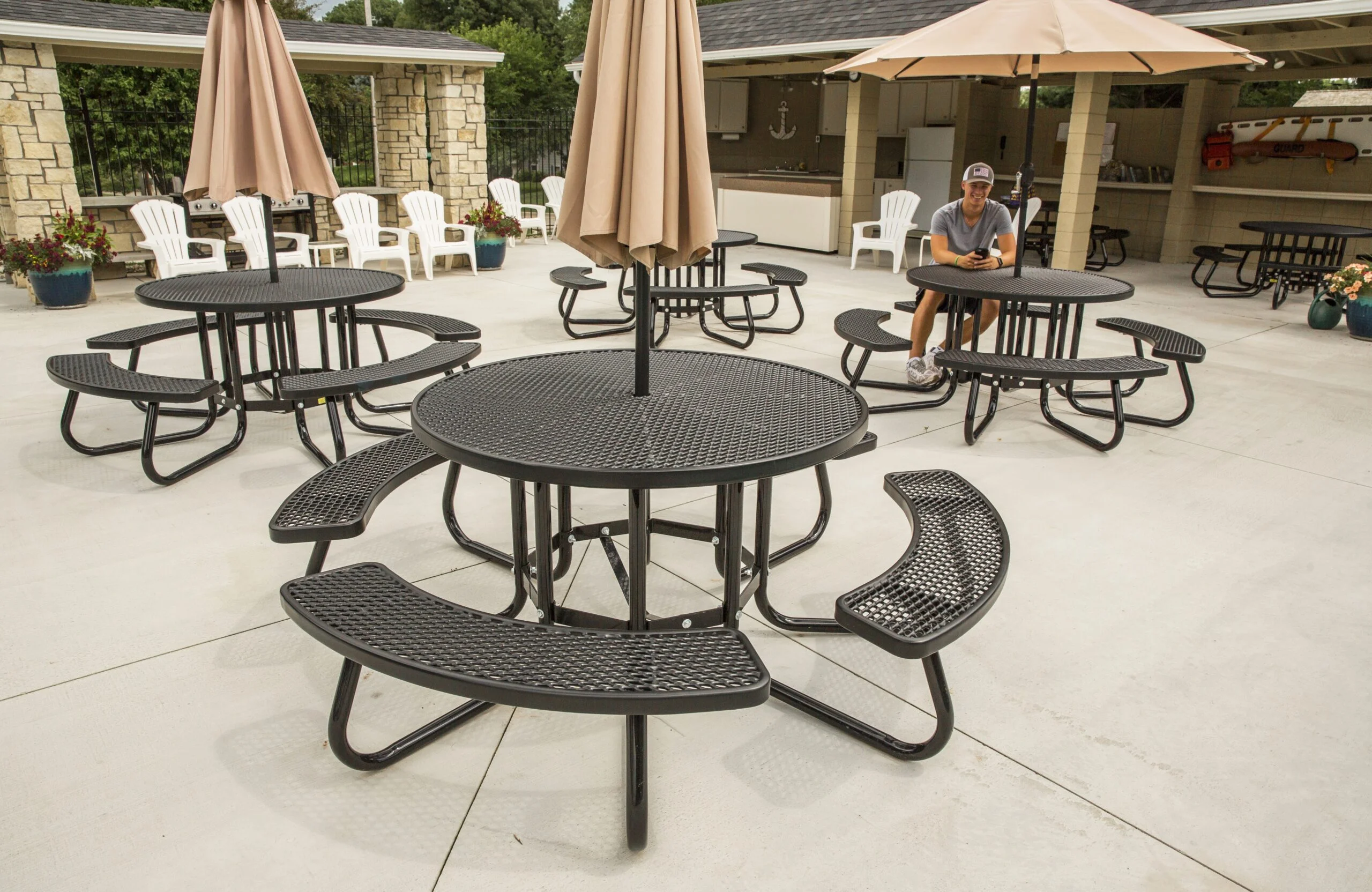 Outdoor picnic tables and umbrellas in a patio setting.
