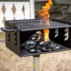 Outdoor grill with charcoal and flames.
