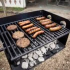 Charcoal grill cooking burgers and sausages.