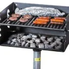 Portable grill with charcoal and food cooking.