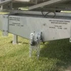 Trailer hitch with caution and weight information.