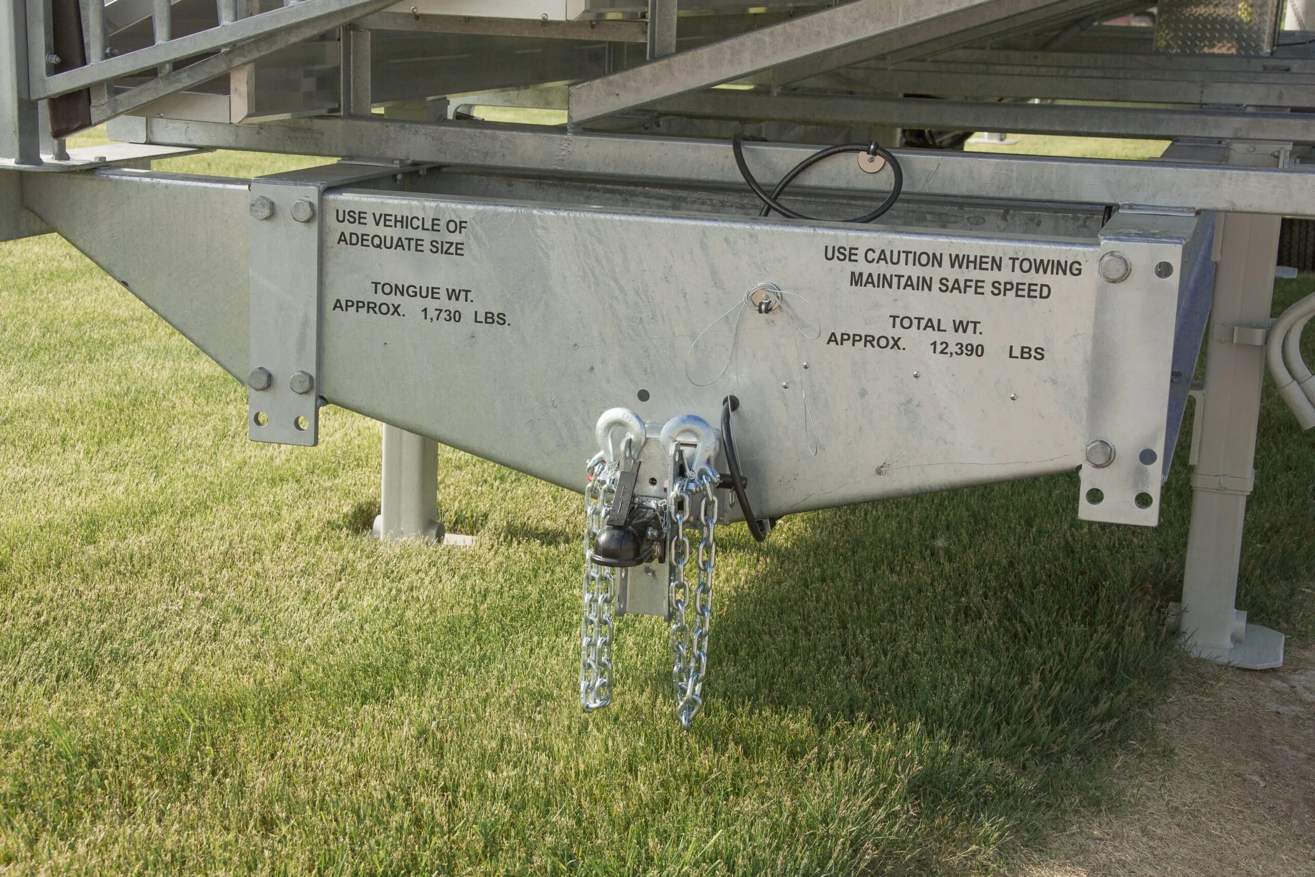Trailer hitch with caution and weight information.