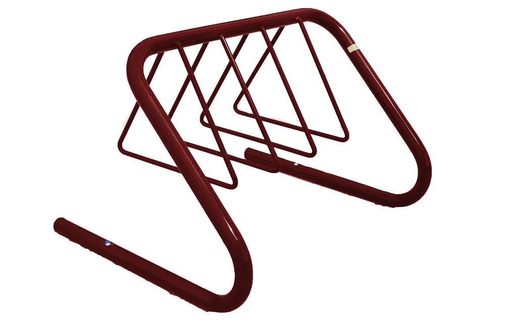 Maroon metal bike rack on white background.
