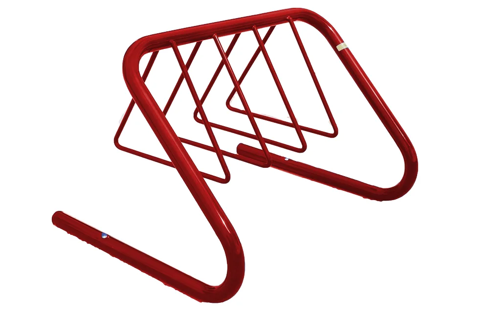 Red metal bike rack on a white background.