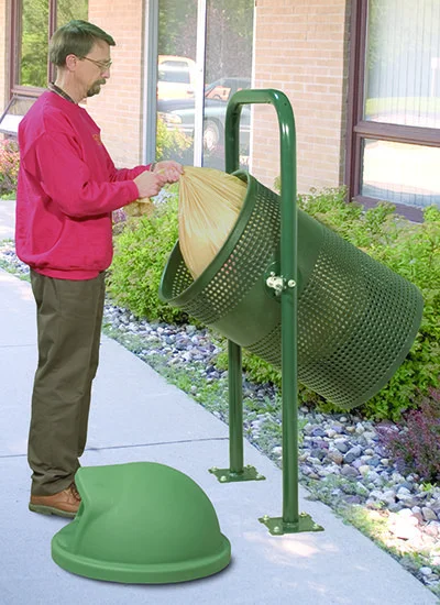 Man using a green outdoor compost bin.