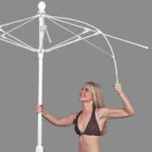 Woman holding a large white umbrella.