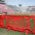 Red plastic barriers on a football field.
