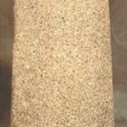 Cylindrical object with a textured surface and a hanging loop.