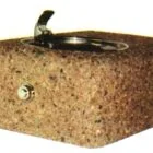 Cork ashtray with a black base and a decorative handle.