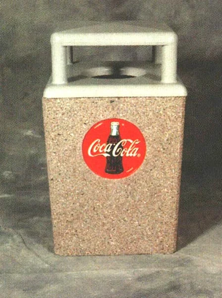 Coca-Cola trash can on concrete surface.