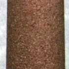 Cylindrical object with textured surface and metallic top.