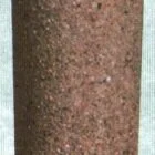 A cylindrical object with a rough, textured surface.