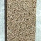 A textured cylindrical object with a metallic top.
