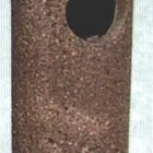 Cylindrical object with a textured surface and a circular opening at one end.