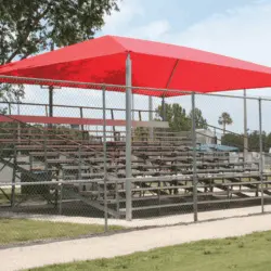 Red canopy over bleachers at a sports field.