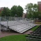 Metal bleachers on a trailer in an outdoor setting.