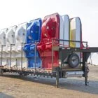 Row of colorful kayaks on a trailer.