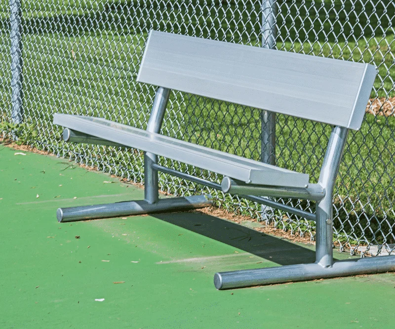 Baseball bench on a green field.