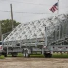 Truck carrying a large load of metal structures on a trailer.