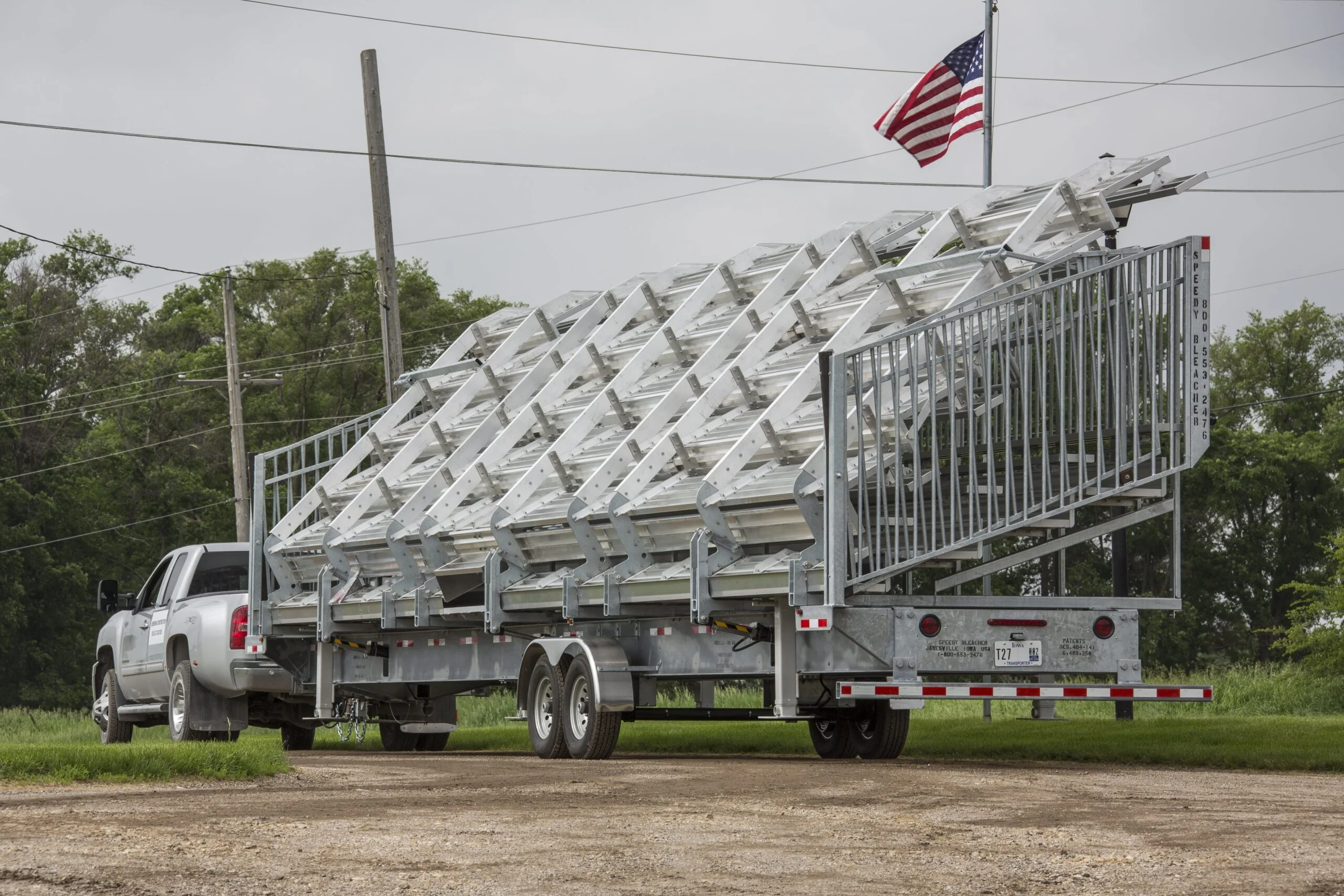Truck carrying a large load of metal structures on a trailer.
