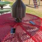 Outdoor charging station on a red table in a playground.