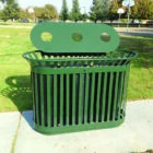Green trash can in a park.